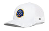 White trucker snapback hat with front circular logo patch and mesh back panel.