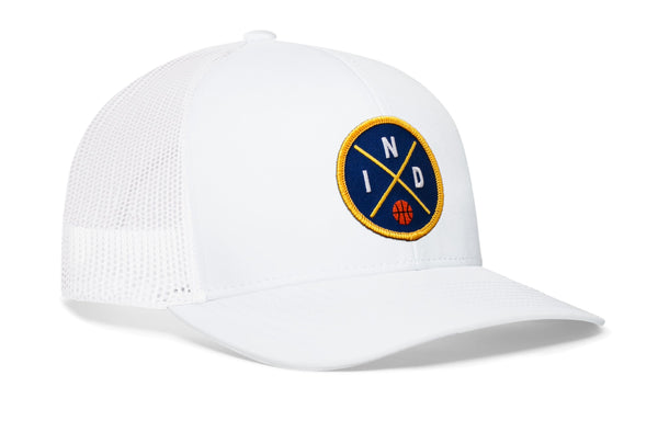 White trucker snapback hat with circular blue-and-gold logo patch on the front.