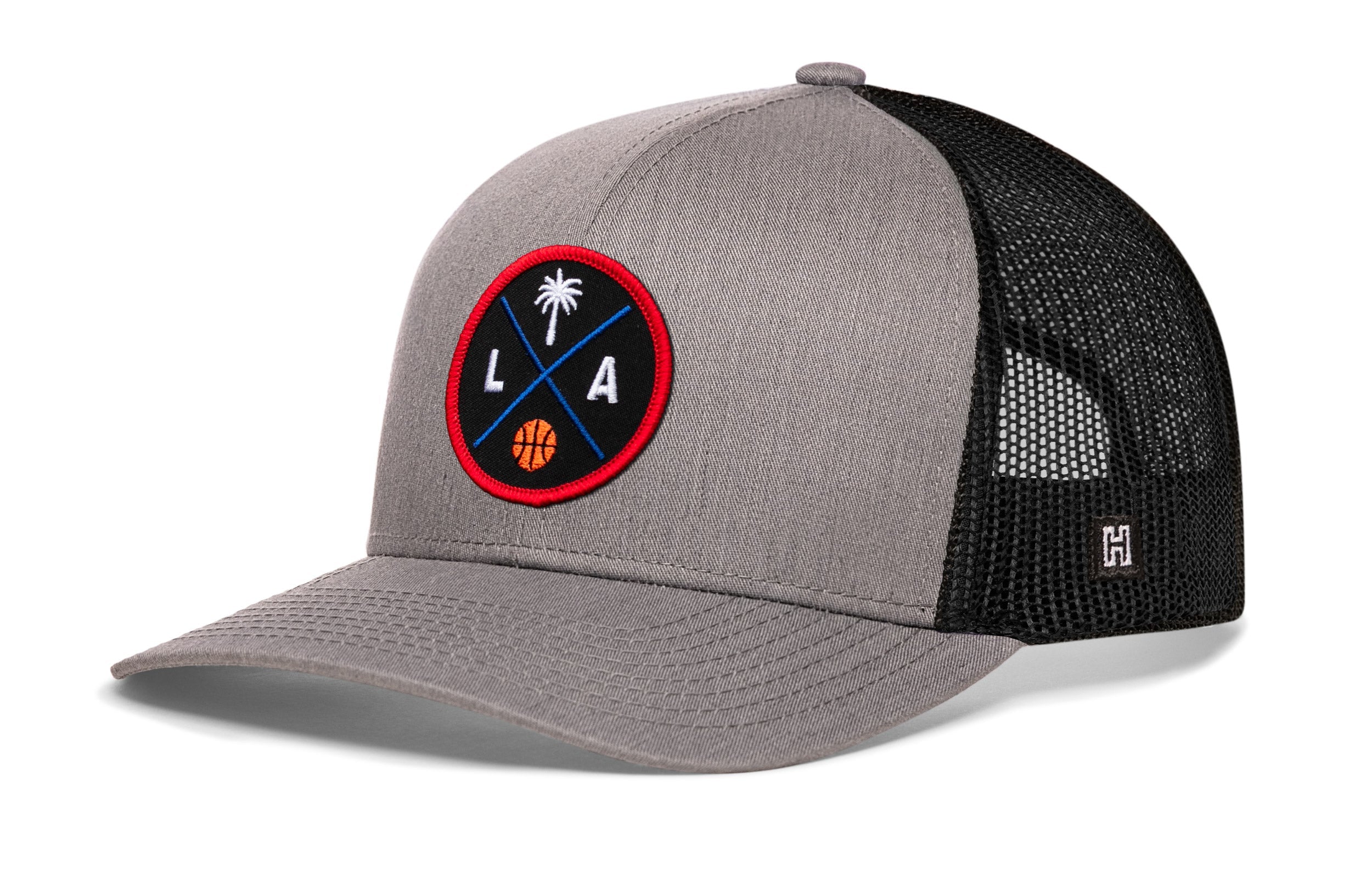 Gray trucker cap with black mesh back and round LA logo patch, snapback closure
