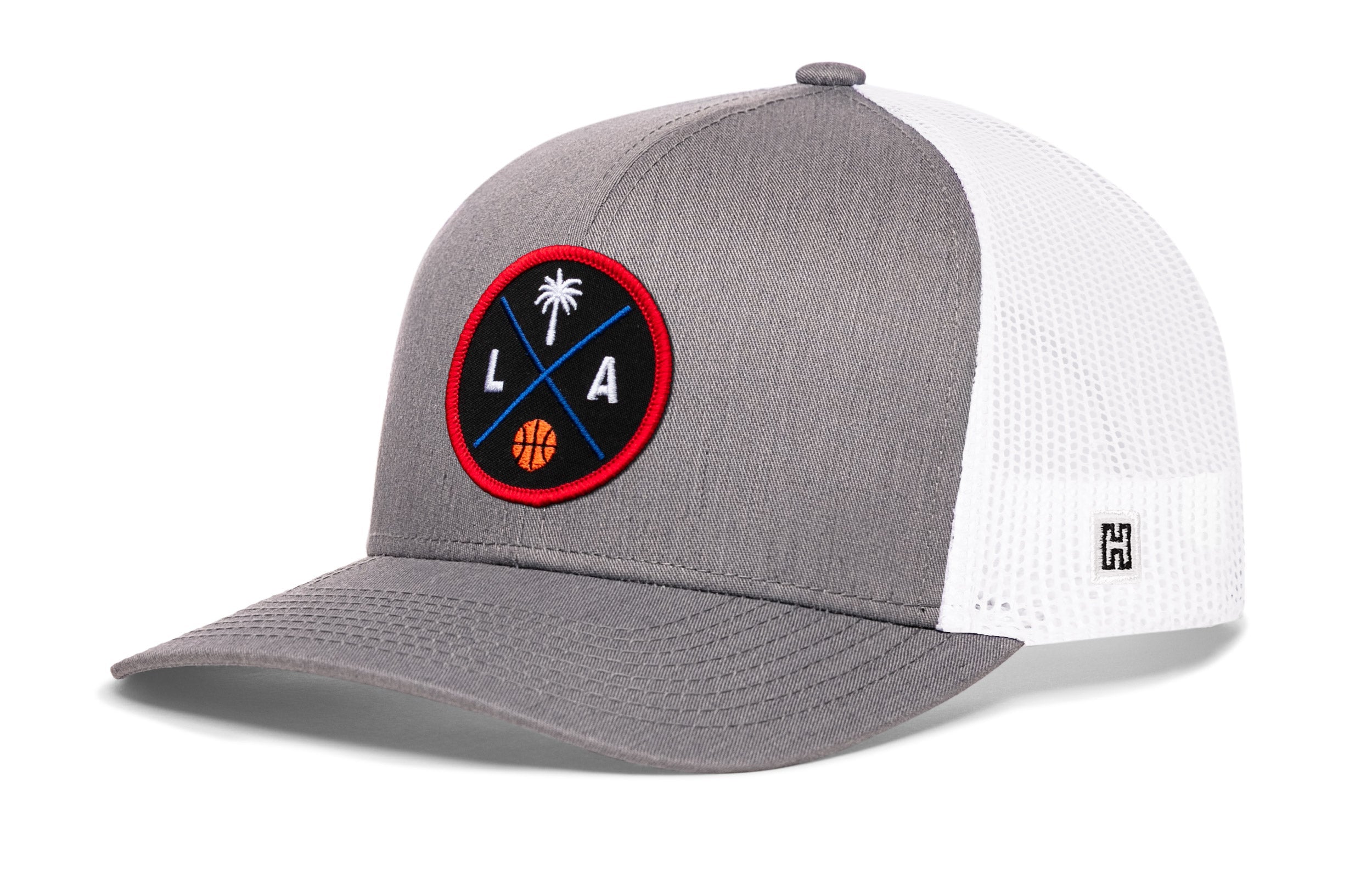 Gray trucker cap with white mesh back and round LA logo patch, snapback closure
