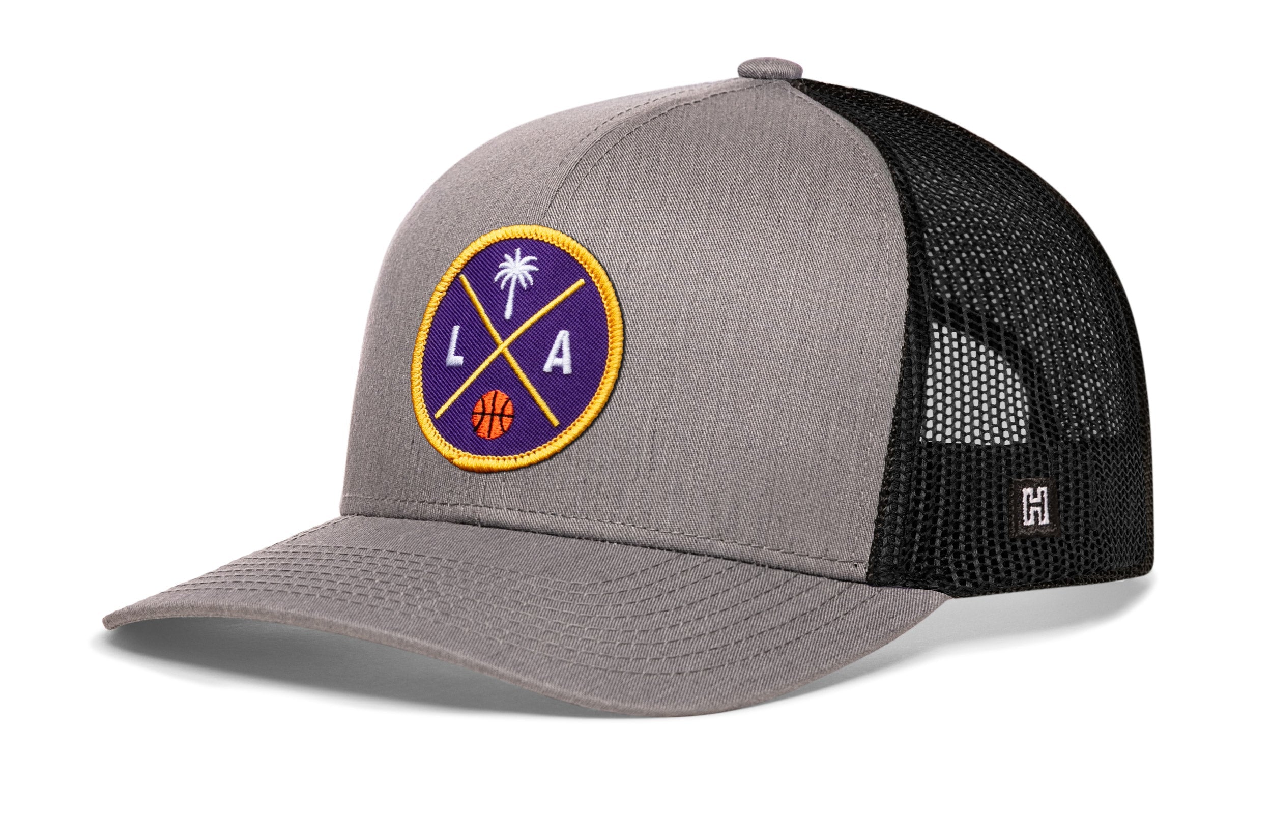 Gray and black trucker hat with circular LA graphic patch on front