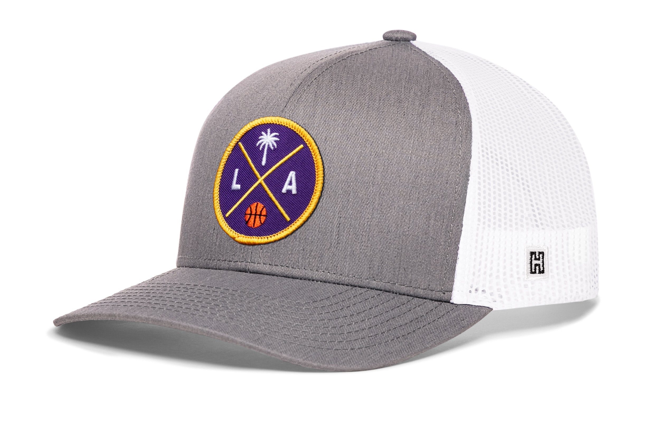 Gray and white trucker hat with circular LA graphic patch and side H logo