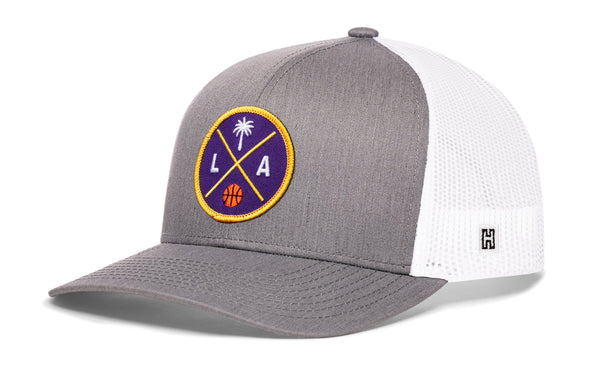 Gray and white trucker hat with circular LA graphic patch and side H logo