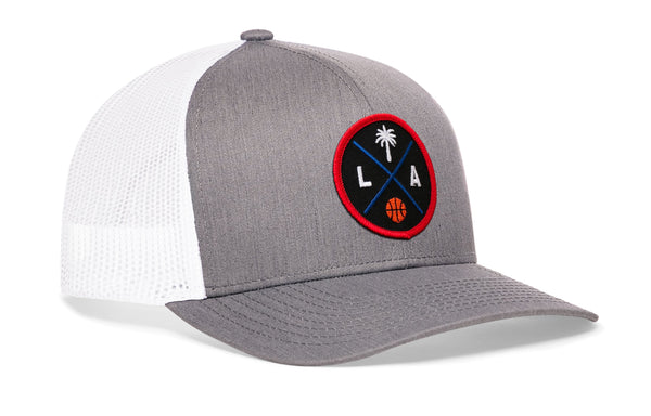 Gray-and-white trucker cap with mesh back and round LA logo patch, curved brim, snapback