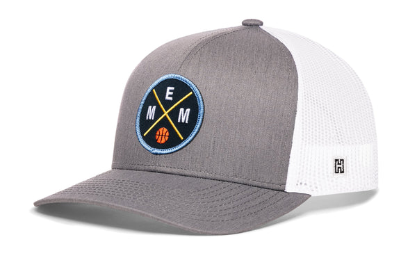 Gray basketball trucker hat with circular EMM logo patch and white mesh back