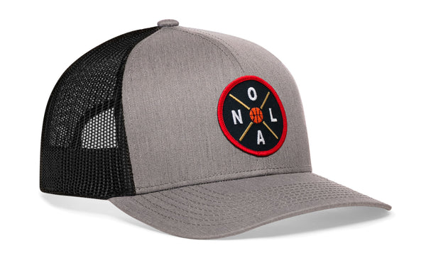 Gray basketball trucker hat, side view, black mesh back and red logo patch