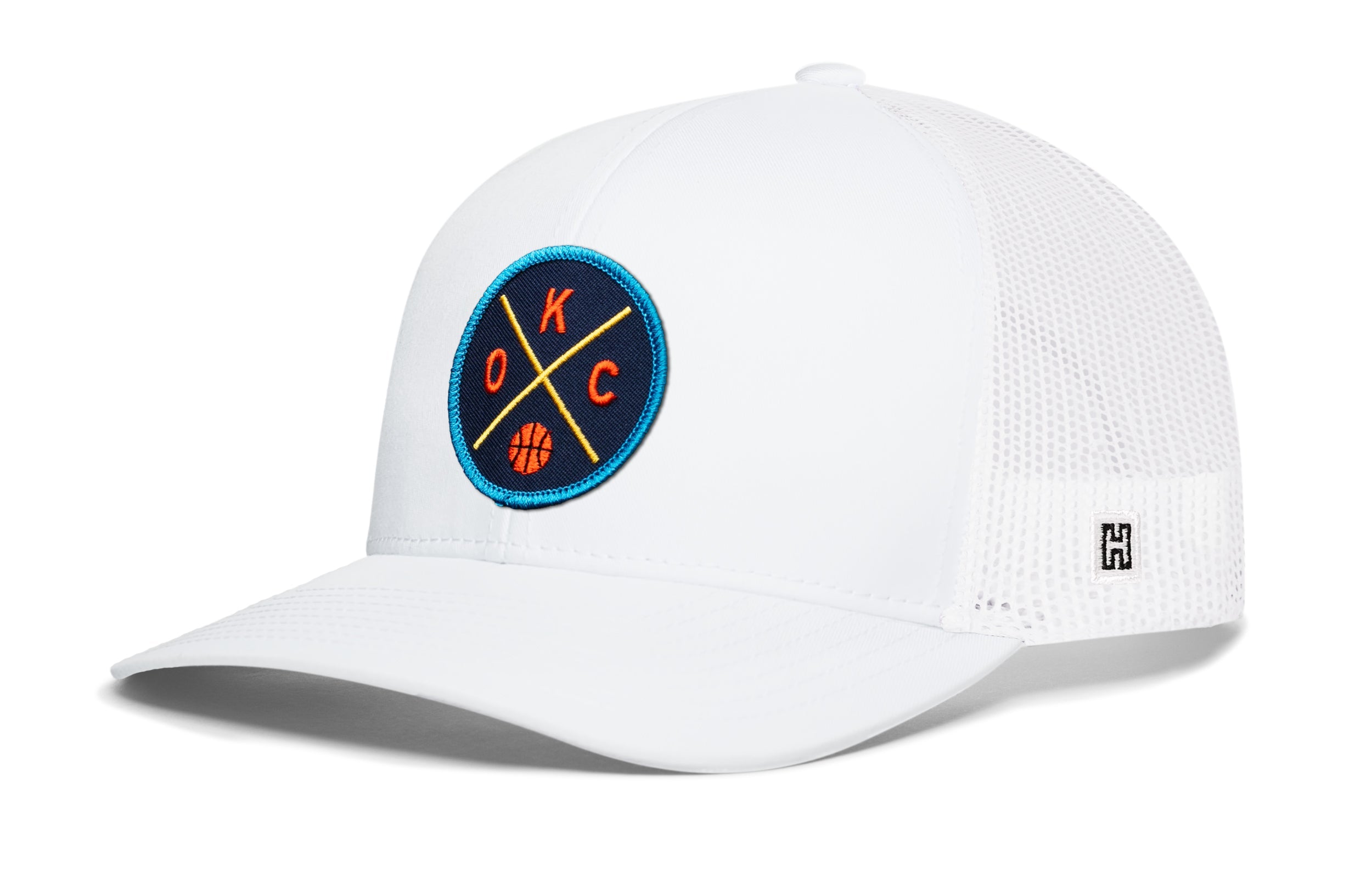 White trucker hat with mesh sides, curved brim, and circular team logo patch.