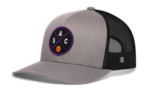 Gray and black basketball trucker hat with mesh back and purple circle logo on front