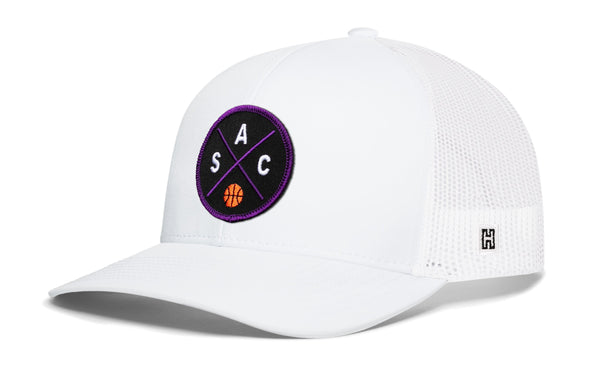 White basketball trucker hat with mesh back and purple circle logo on front