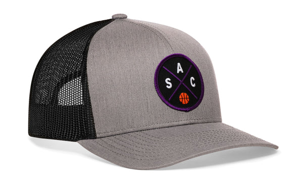 Gray and black basketball trucker hat with mesh back and purple circle logo on front