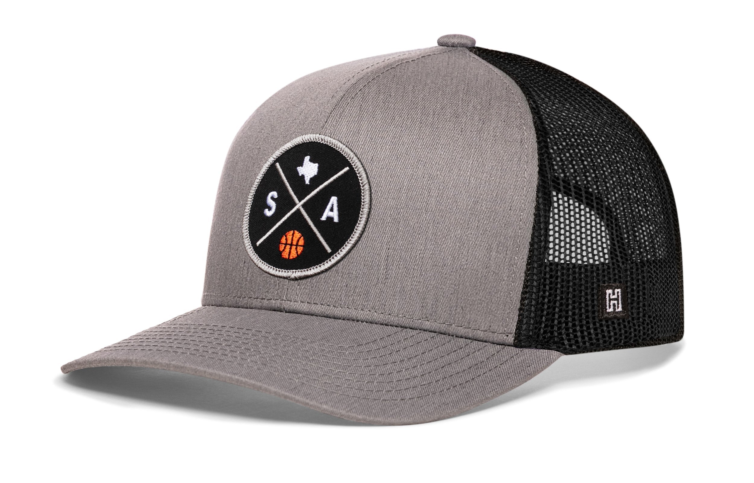 Gray trucker hat with black mesh back, front circular SA graphic patch, and side H logo