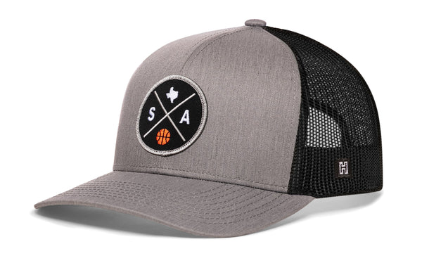 Gray trucker hat with black mesh back, front circular SA graphic patch, and side H logo