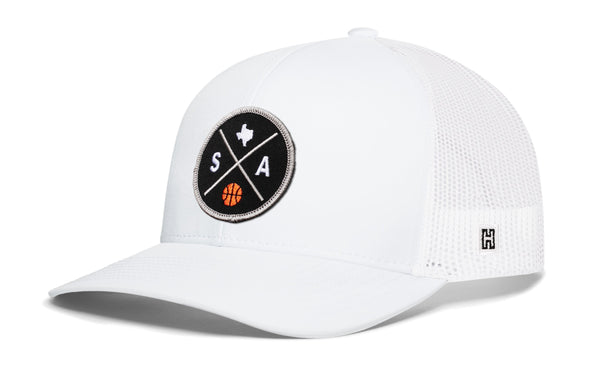 White trucker hat with mesh back, front circular SA graphic patch, and side H logo