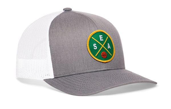 Light gray trucker hat with circular basketball logo patch and white mesh side panels