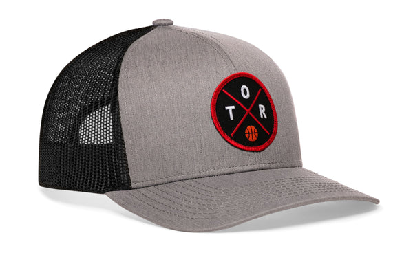 Gray front basketball trucker hat with circular logo patch, black mesh back panels.