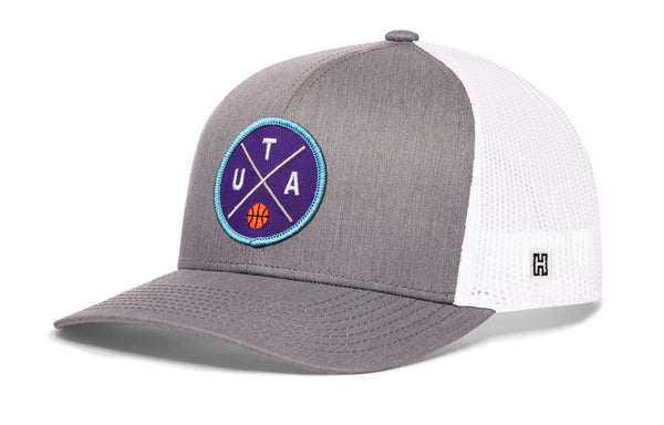 Gray trucker snapback hat with blue logo patch and white mesh back, H tag