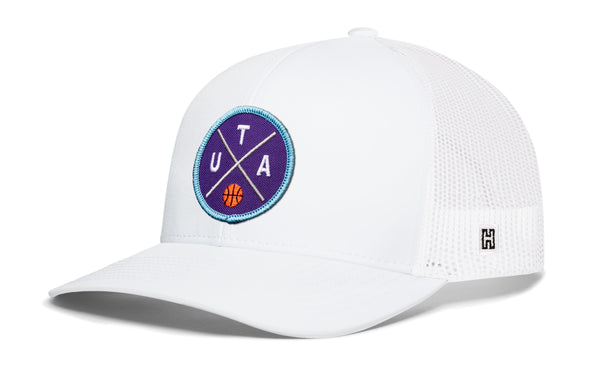 White trucker snapback hat with blue logo patch and white mesh back, H tag