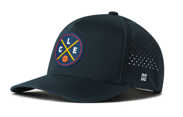 Navy 5-panel snapback hat with circular team logo patch and perforated side mesh.