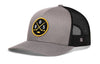 Gray/black hockey trucker hat with snapback, round front patch and mesh side panels