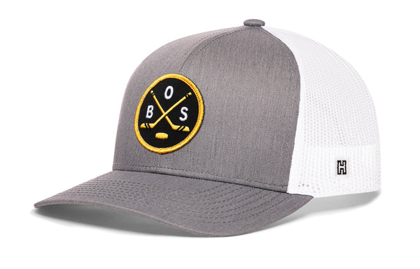 Gray hockey trucker hat with snapback, round front patch logo and white mesh side panels