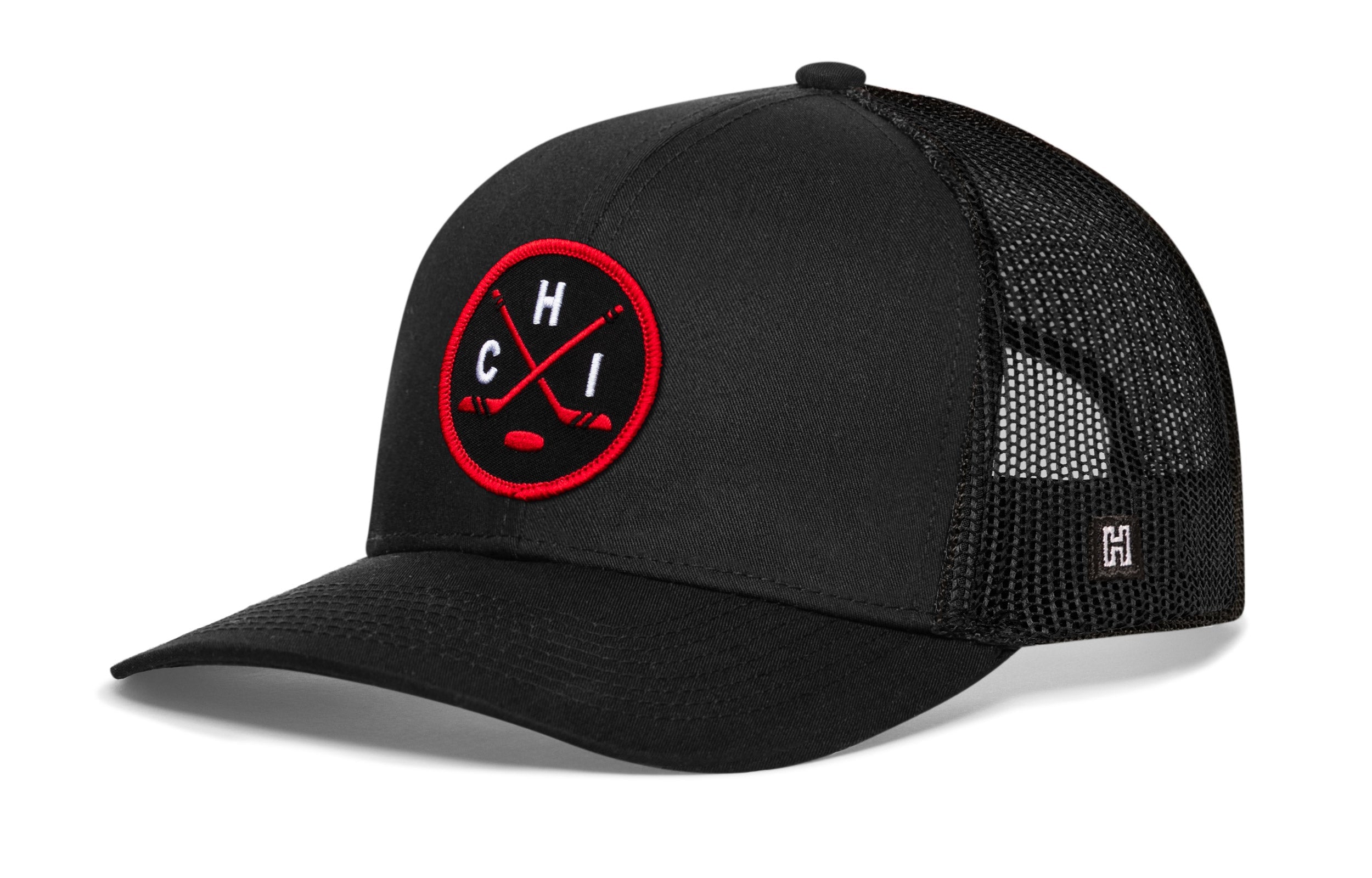 Black trucker cap with red-and-black circular emblem and front logo, mesh side panels.