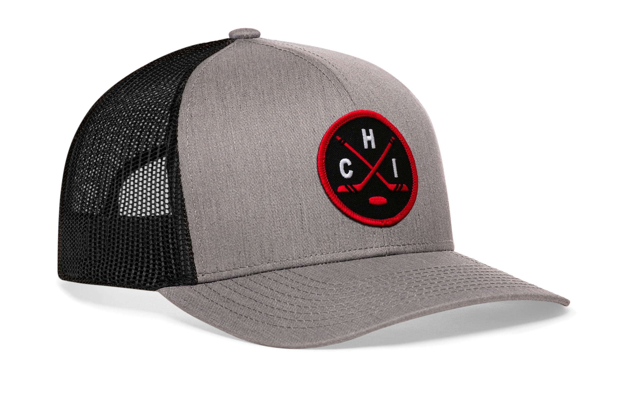 Gray front trucker cap with black mesh side panels and red-and-black circular emblem.