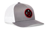 Gray trucker cap with white mesh back and red-and-black circular emblem patch on front.