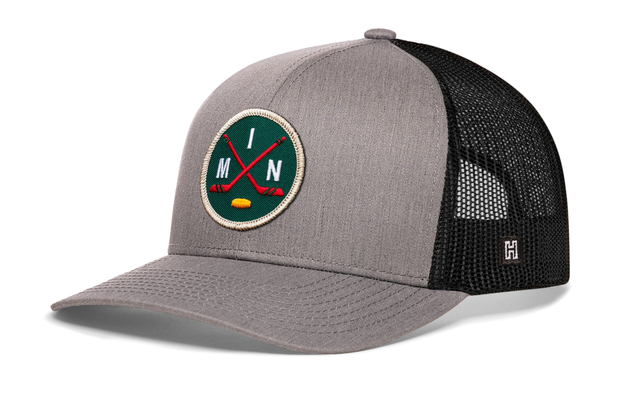 Gray front trucker hat with black mesh back, round hockey logo patch, and H side emblem.