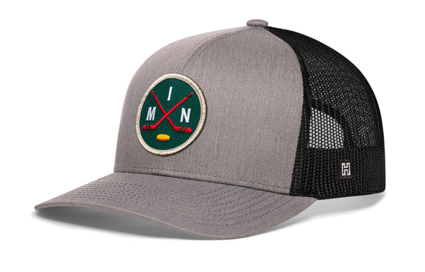 Gray front trucker hat with black mesh back, round hockey logo patch, and H side emblem.