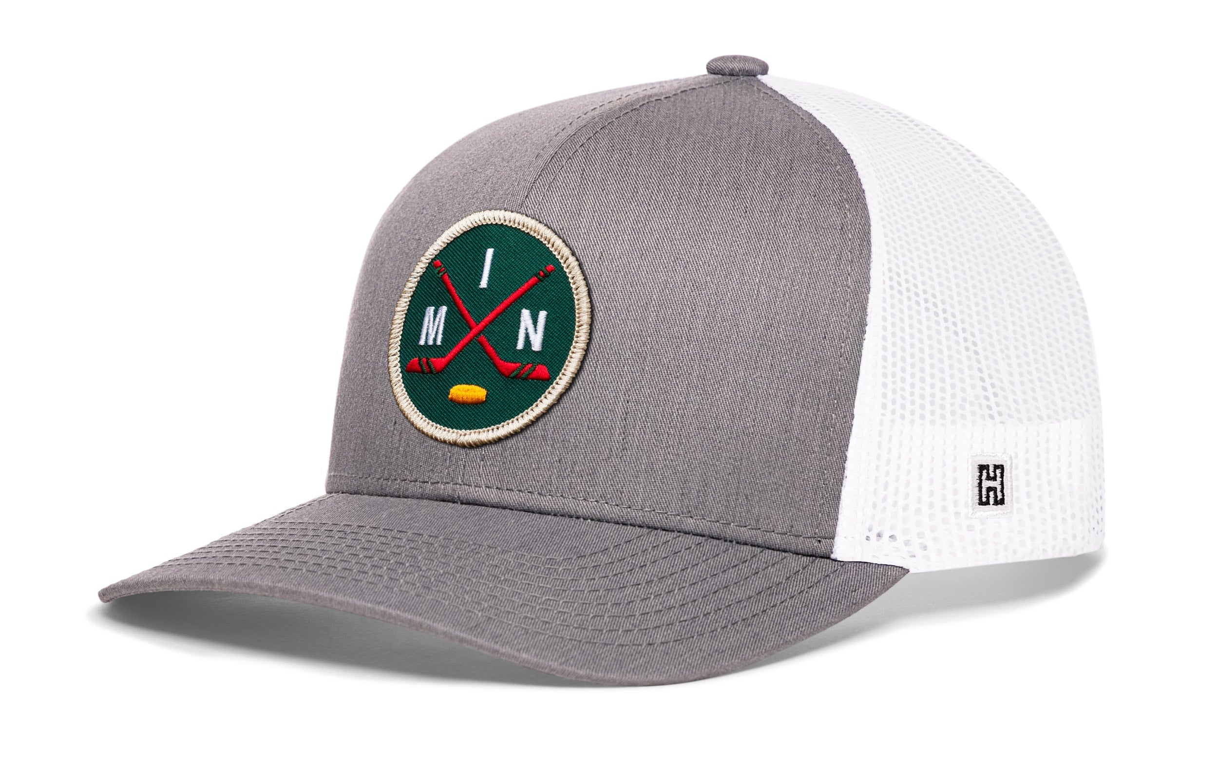 Gray and white trucker hat with round hockey logo patch, mesh back, and H side emblem.