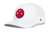 White trucker hat with mesh side panels, curved brim, and red circular crest patch on front