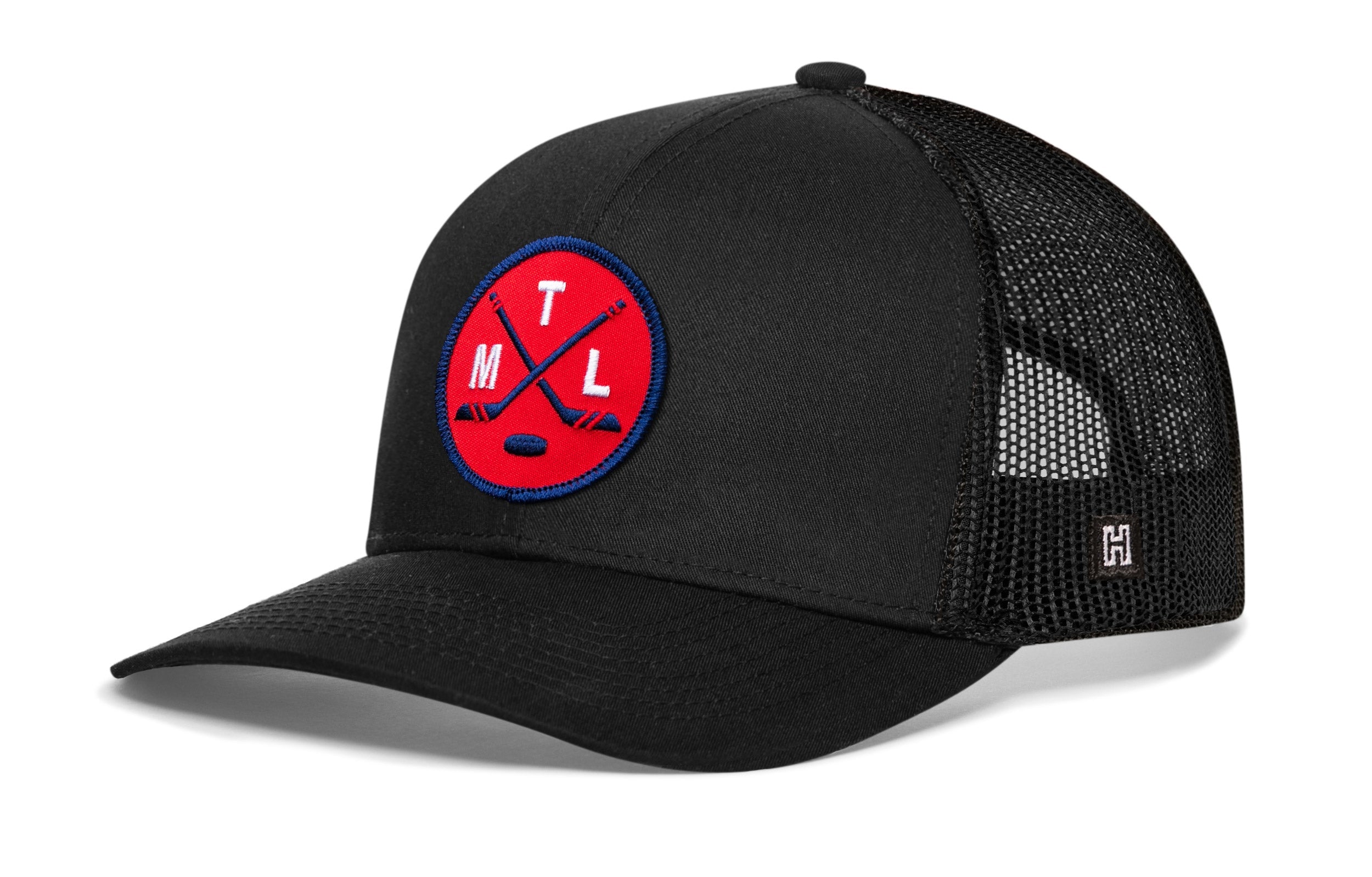 Black trucker hat with mesh sides, curved brim, and red circular crest patch on front