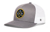 Gray and white trucker cap with circular logo patch and mesh side panels.