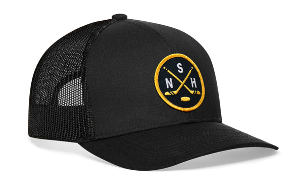 Black trucker cap with circular logo patch, curved brim, and mesh back.