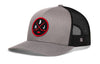 Gray hockey trucker cap with red logo patch, black mesh side panels, snapback closure