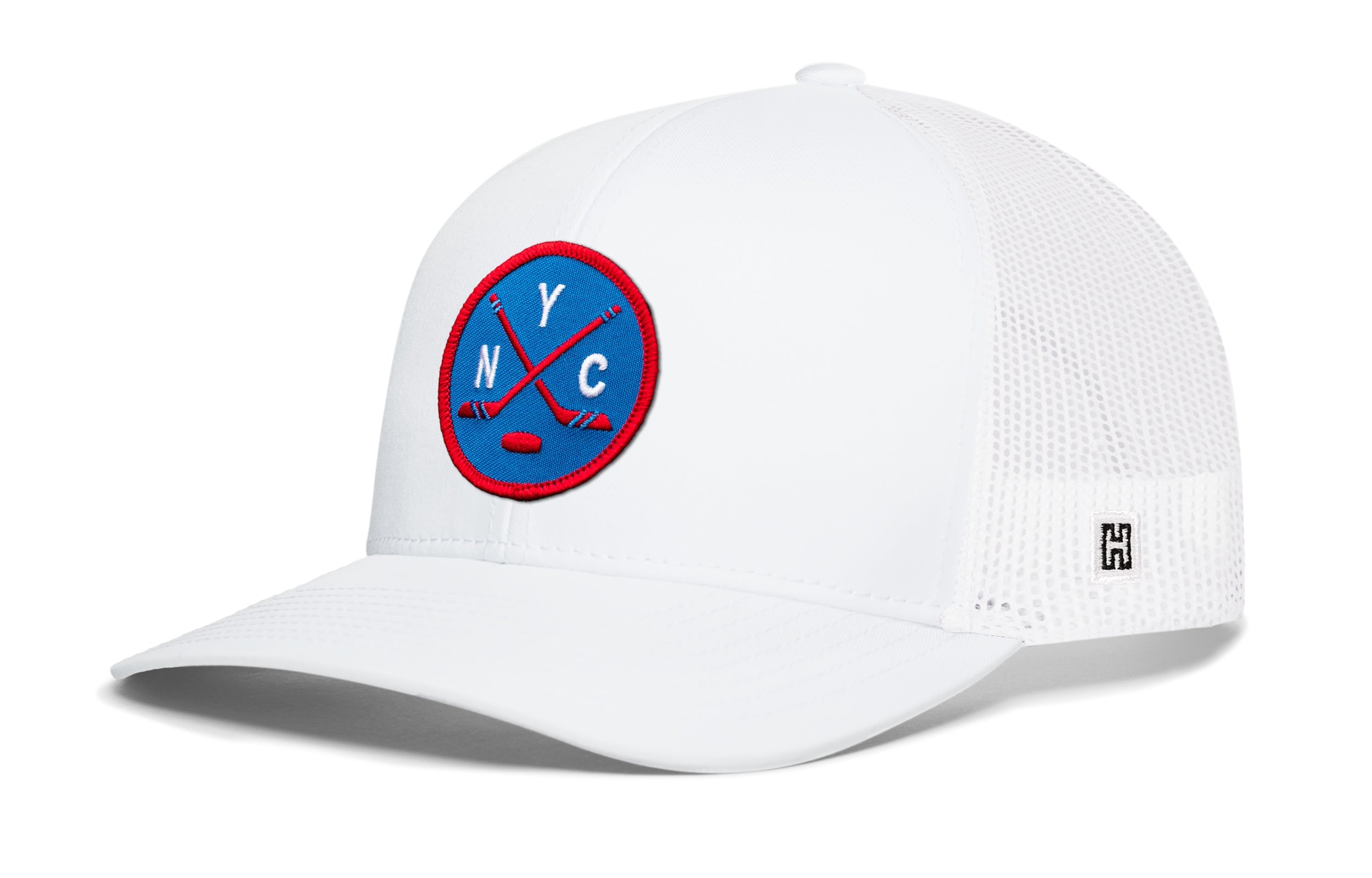 White hockey trucker hat with circular front patch, mesh back, snapback closure.