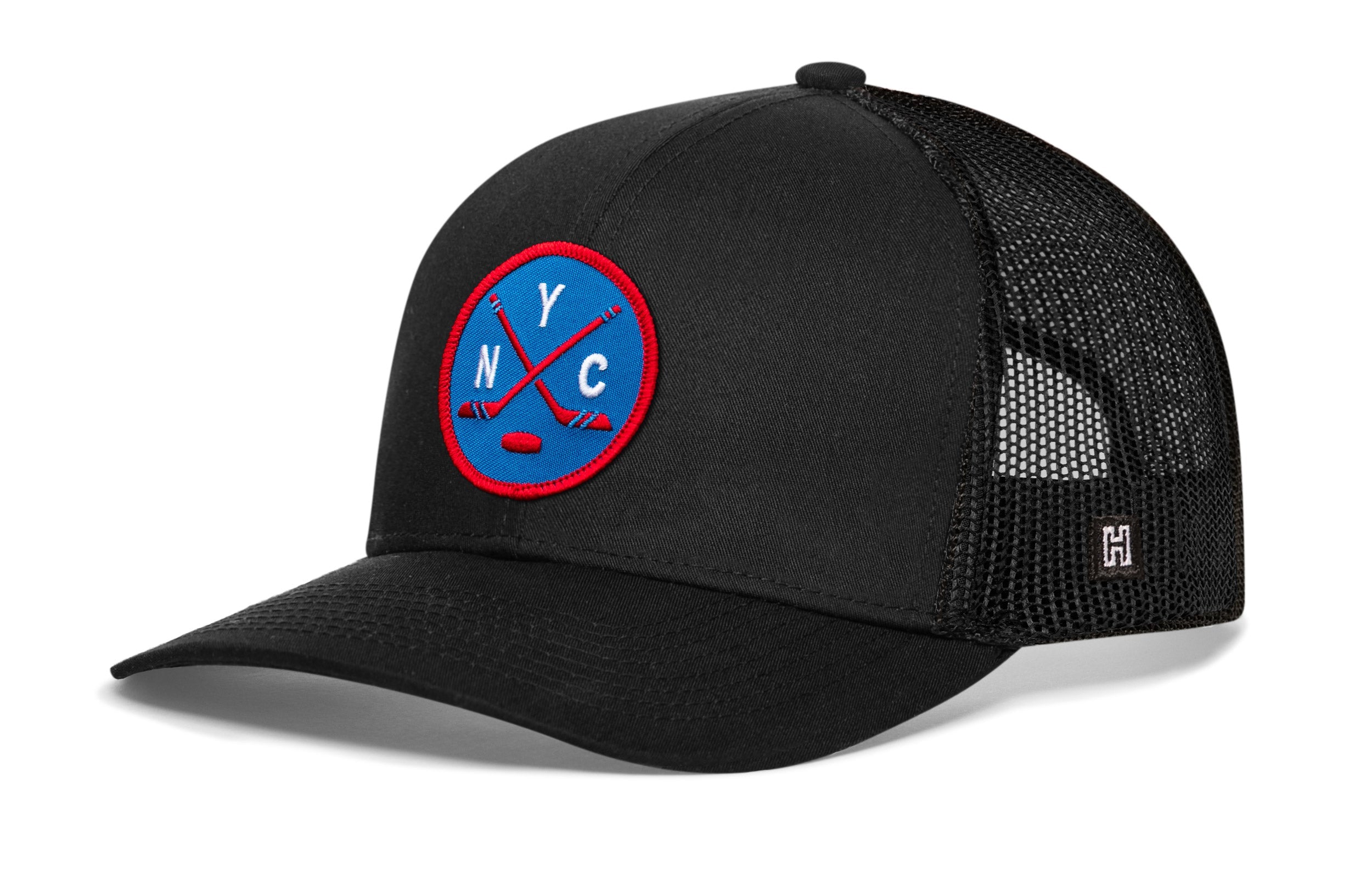 Black hockey trucker hat with circular front patch, mesh back, snapback closure.