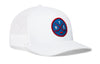 White hockey trucker hat with circular logo patch, mesh back, curved brim.