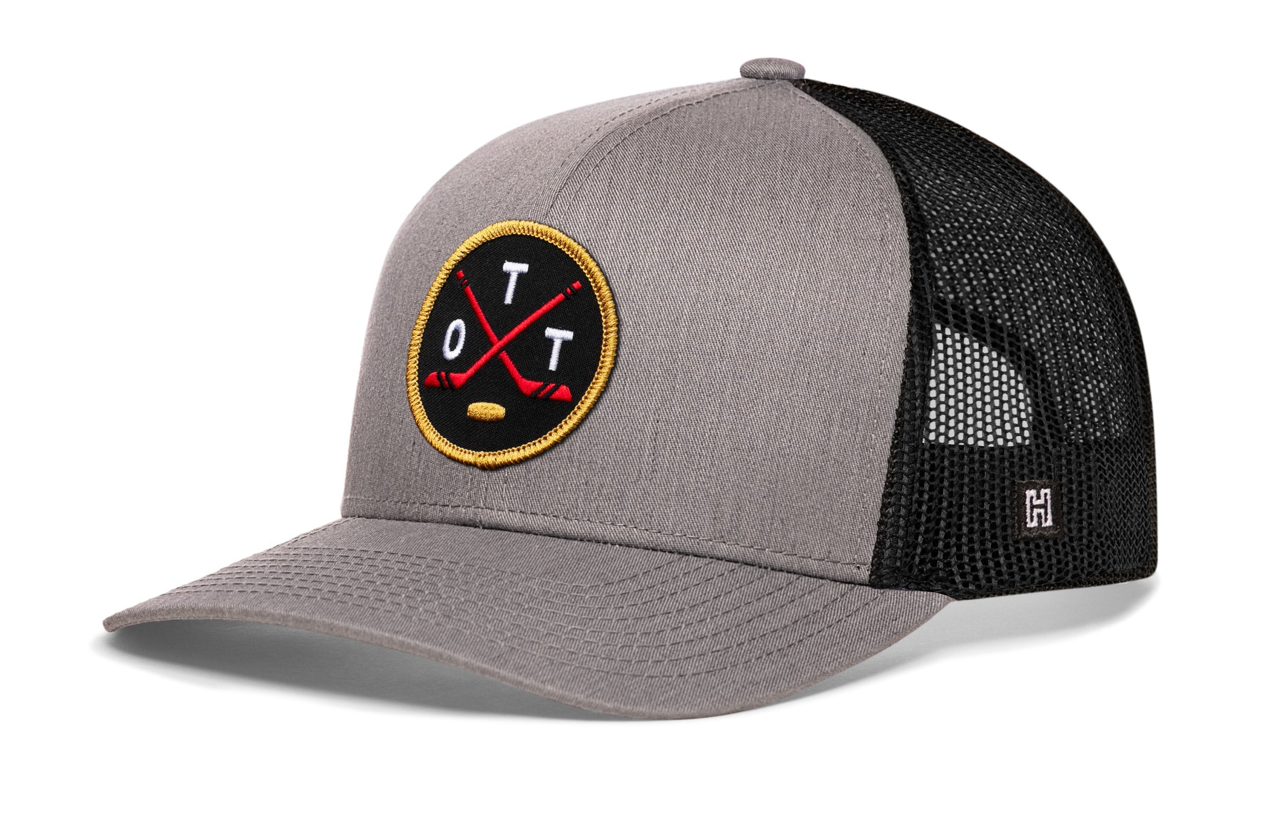 Gray trucker snapback cap with hockey logo patch and black mesh side panels