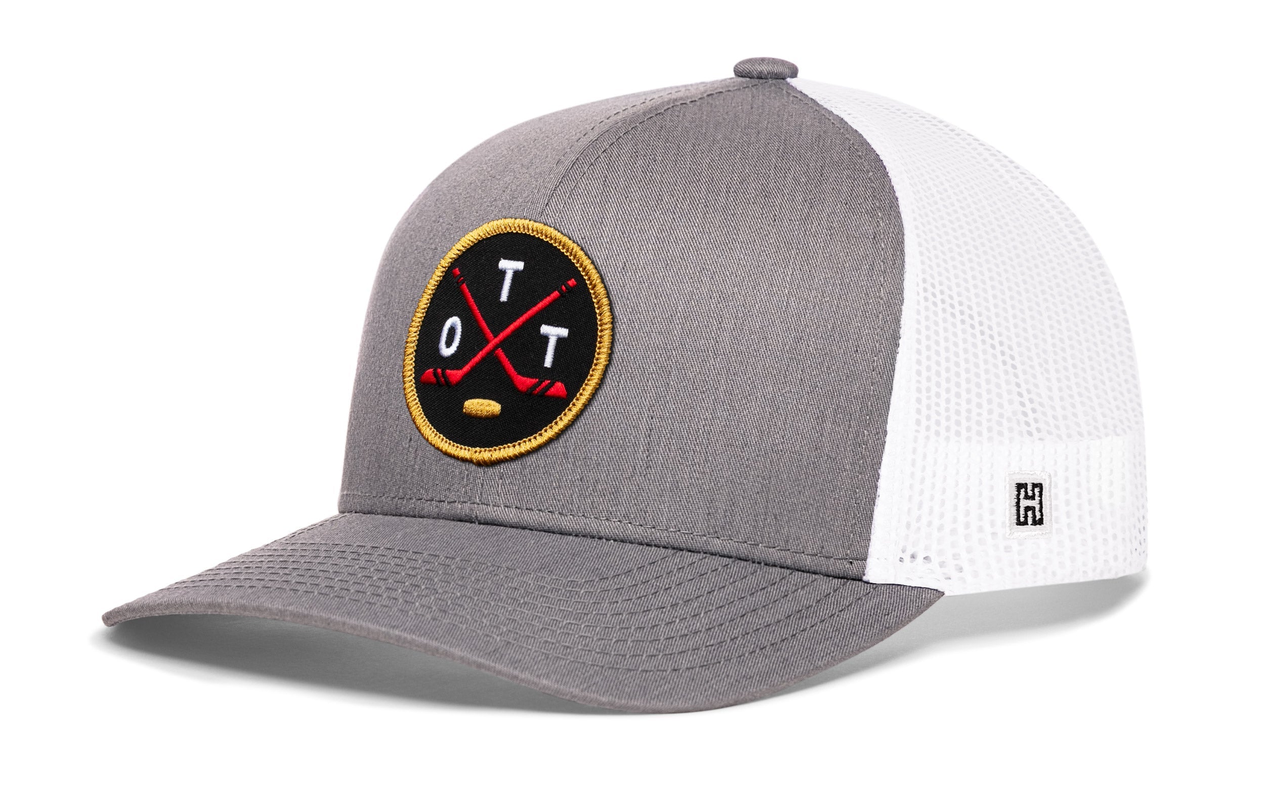 Gray trucker snapback cap with hockey logo patch and white mesh side panels