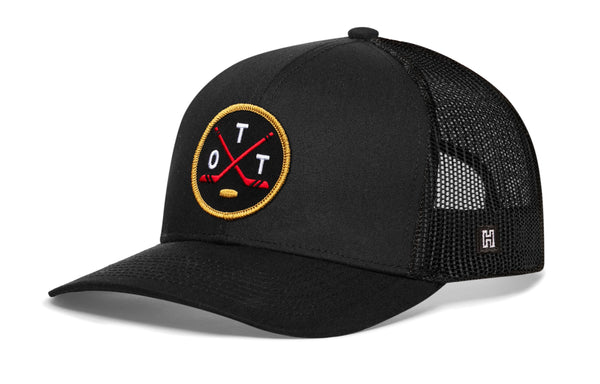 Black trucker snapback cap with hockey logo patch and mesh side panels