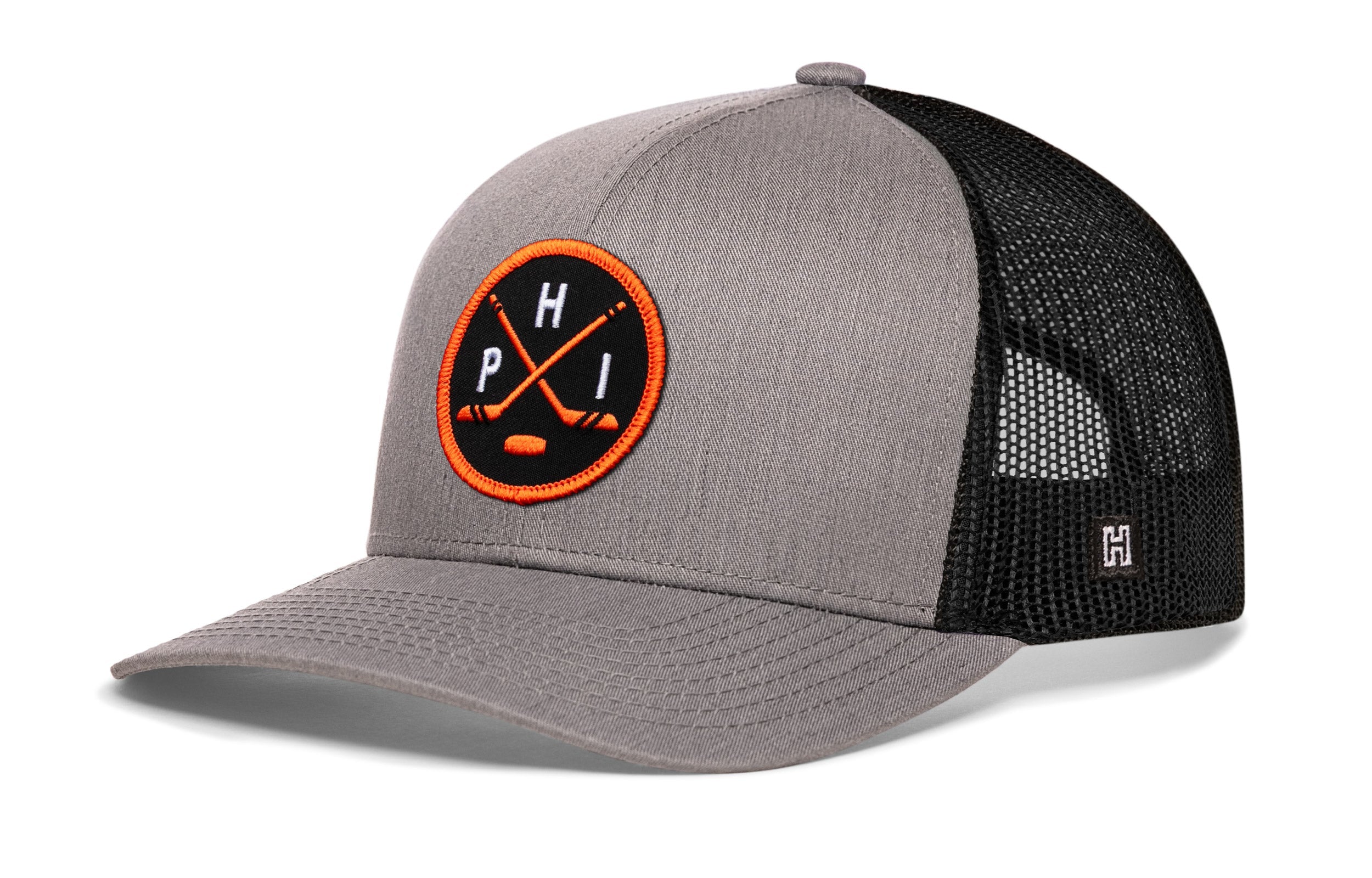 Gray trucker cap with black mesh back and orange circular logo patch, curved brim