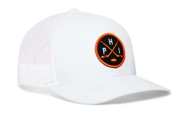 White trucker cap with orange circular logo patch, mesh side panel, and curved brim