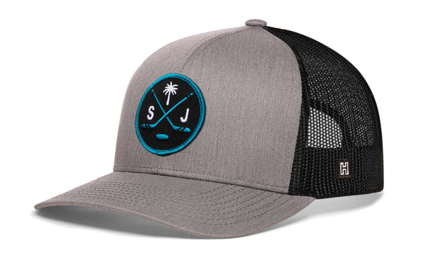 Gray trucker cap with mesh back, circular front logo patch, and small side H mark.