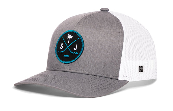 Gray-and-white trucker cap with mesh back, circular front logo patch, and small side H mark.