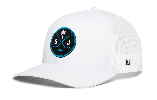 White trucker cap with mesh back, circular front logo patch, and small side H mark.