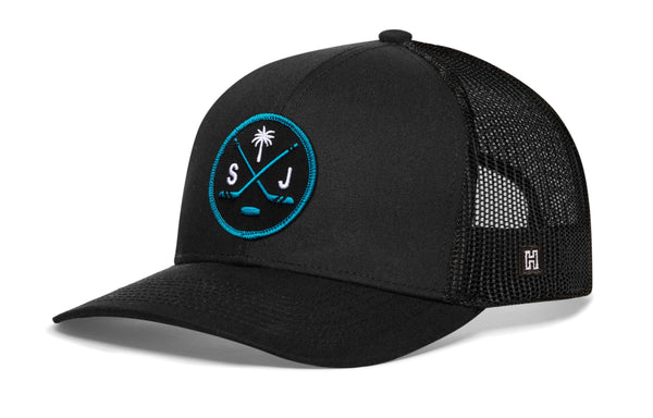 Black trucker cap with mesh back, circular front logo patch, and small side H mark.
