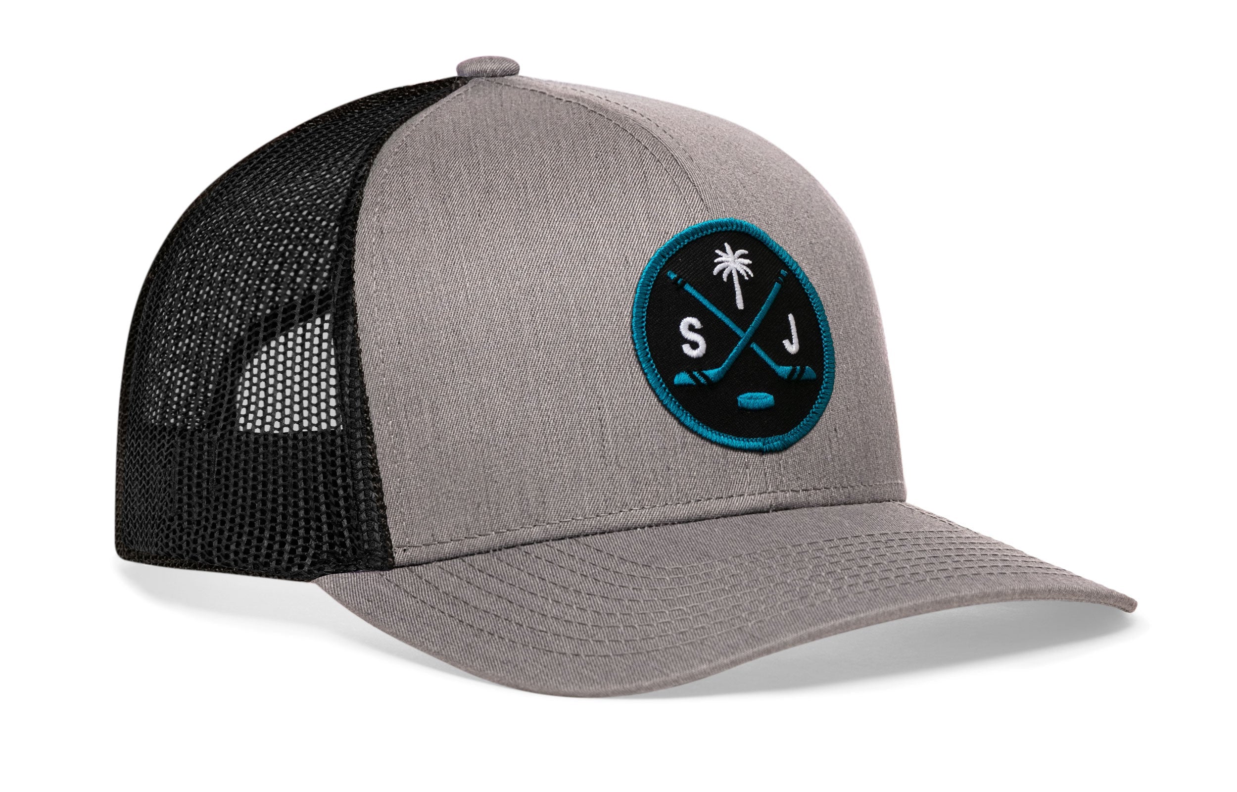 Gray trucker cap with black mesh side panels, circular front logo patch, curved brim.