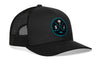 Black trucker cap with mesh side panels, circular front logo patch, and curved brim.