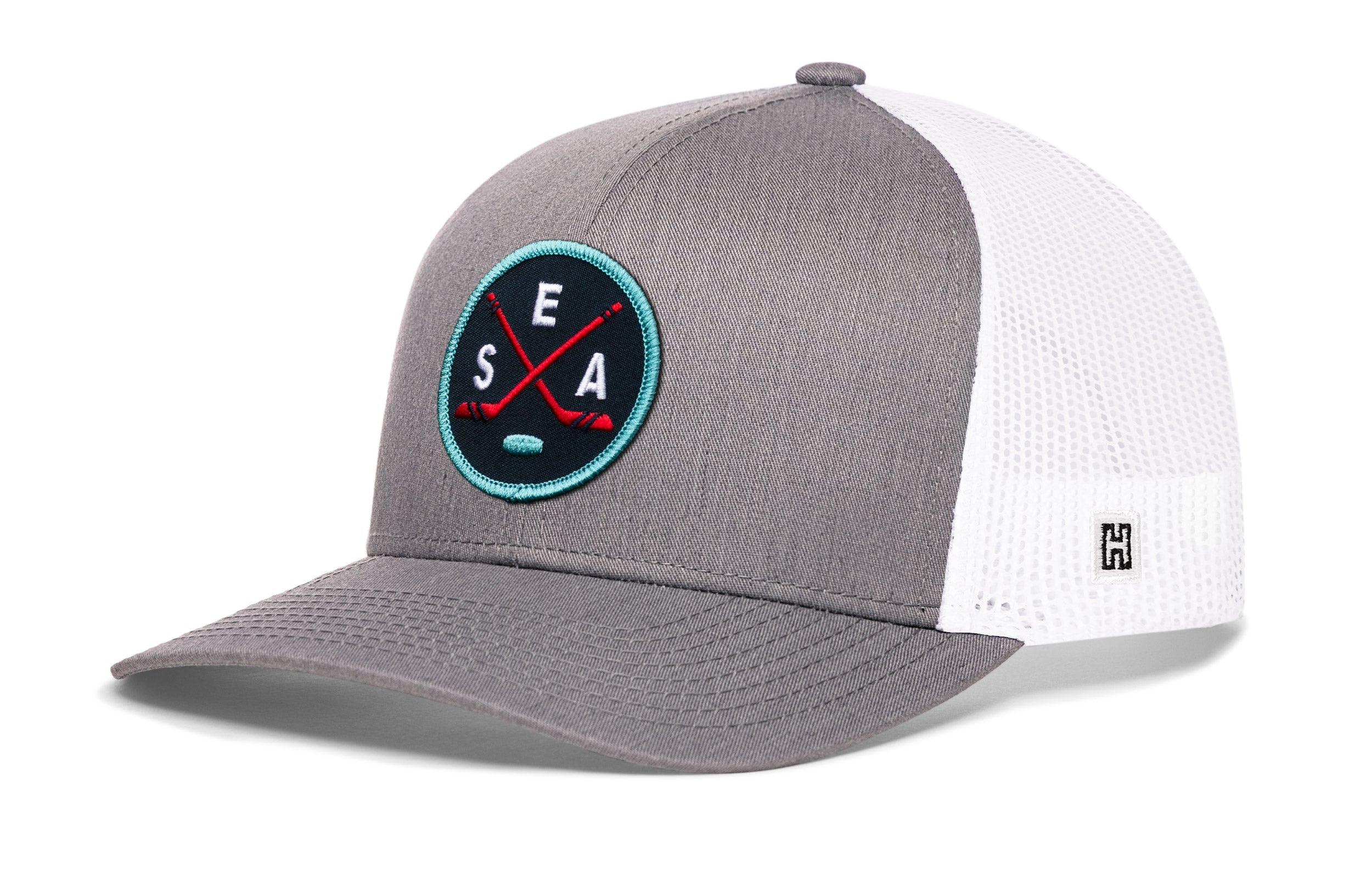 Gray snapback trucker hat with white mesh back and circular SEA X logo patch